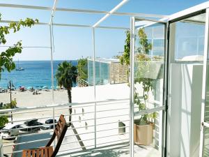 a balcony with a view of the beach at Mario Schifano in Scilla