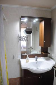 a bathroom with a sink and a mirror at Melpomeni Villa in Mythimna +17 photos