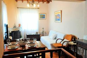 a living room with a table and a couch at Melpomeni Villa in Mythimna