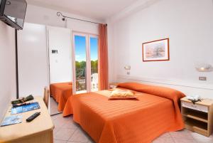 Postel nebo postele na pokoji v ubytování Hotel Corallo + 11 fotografií