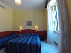 Postel nebo postele na pokoji v ubytování Hotel Ferrari