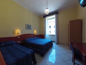 Postel nebo postele na pokoji v ubytování Hotel Ferrari