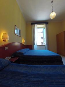 Postel nebo postele na pokoji v ubytování Hotel Ferrari
