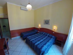 Postel nebo postele na pokoji v ubytování Hotel Ferrari