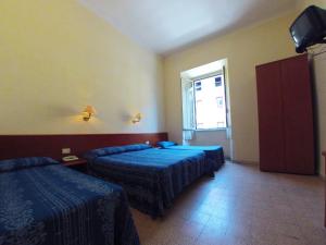 Postel nebo postele na pokoji v ubytování Hotel Ferrari