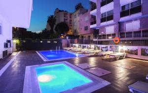 a swimming pool in the middle of a building at White Star Antalya in Antalya