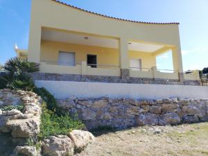 a house on a hill with a stone wall at Villa Fiorella in Sciacca