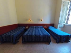 Postel nebo postele na pokoji v ubytování Hotel Ferrari