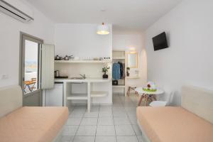 a room with a kitchen and a living room at Olive Tree Suites in Fira +19 photos