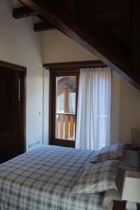 una camera da letto con un letto e una finestra di Acogedora casita en el Pallars a Isil