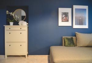 a bedroom with a bed and a dresser with a mirror at Apartments Lucija in Zadar
