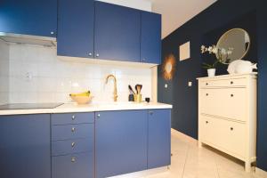 a kitchen with blue cabinets and a sink at Apartments Lucija in Zadar