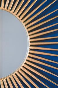a mirror on a wall with a blue at Apartments Lucija in Zadar