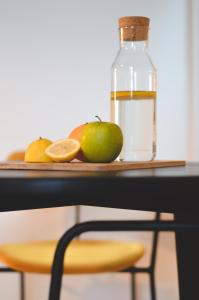 a table with a bottle of water and some fruit at Apartments Lucija in Zadar