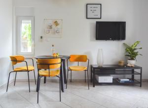 a dining room with a table and chairs and a tv at Apartments Lucija in Zadar