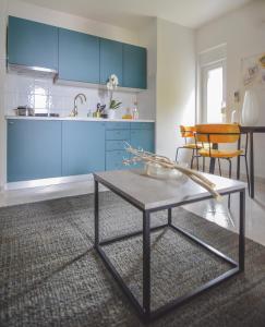 a kitchen with blue cabinets and a table at Apartments Lucija in Zadar +33 photos