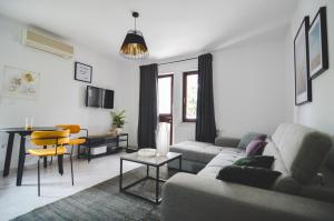 a living room with a couch and a table at Apartments Lucija in Zadar