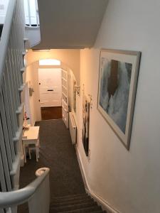 a hallway with a stairway with a white door at Sherwood Hotel in Margate
