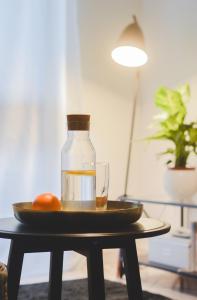 a bottle and a plate with a glass on a table at Apartments Lucija in Zadar