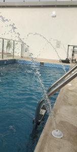 a swimming pool with water shooting into the air at شاليه الماسة in Taif