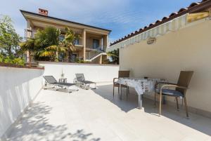 a patio with chairs and a table on a building at Apartments Janko in Rovinj