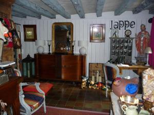 a living room with a table and a mirror at Escale de Loire in Chouzé-sur-Loire