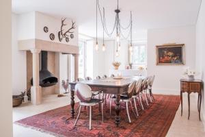 a dining room with a table and chairs and a fireplace at Eighteen21 Houses - Quinta Velha in Sintra