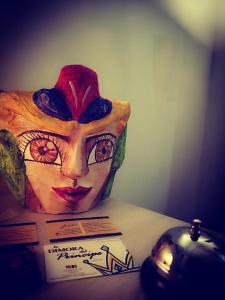 a mask sitting on top of a box on a table at La Dimora del Principe - Appartamento in Catania