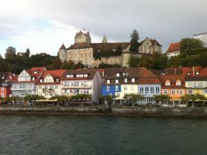 a group of buildings next to a body of water at Hotel la Perla in Meersburg