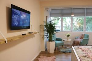 a living room with a television on a wall at Casa Abi in Tirana