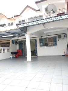 a large white house with a large patio at D'Rusa Homestay in Port Dickson
