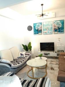 a living room with a couch and a table at D'Rusa Homestay in Port Dickson