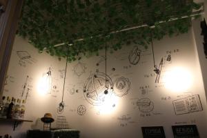 a wall with drawings on it with lights on it at High Hostel Rosario in Rosario