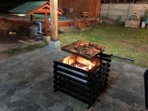 a fire pit in a backyard with a grill at Casa de Campo Reina Margarita in Santa Cruz