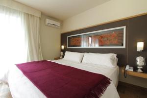 Cama ou camas em um quarto em Plaza Paradiso Petit Hotel
