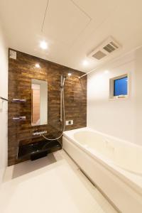 uma casa de banho com uma banheira e um lavatório em Yurian em Kanazawa