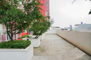une passerelle avec des arbres et des plantes sur un bâtiment dans l'établissement Best Price 2BR at Taman Melati Margonda Apartment By Travelio, à Depok