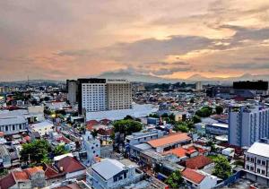 
a city with lots of buildings and a sky background at Gumaya Tower Hotel in Semarang
