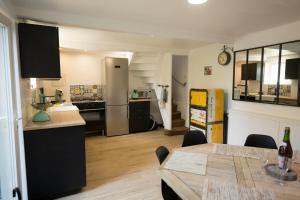 a kitchen and living room with a table and a counter at Atelier 39bis in Honfleur