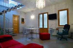 a living room with chairs and tables and a chandelier at Sogni D'Oro in Agrigento