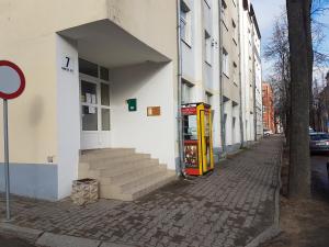 ein Gebäude mit einer Telefonzelle an der Seite einer Straße in der Unterkunft Apartament Erfolg 11 in Daugavpils