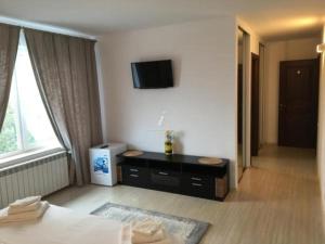 a hotel room with a bed and a tv on the wall at VILA REGAL Mamaia in Mamaia +93 photos