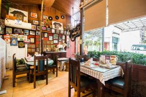 a restaurant with a table and chairs in a room at Hotel Ashrey in Dehradun