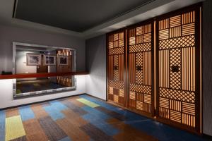 a room with a pair of wooden doors at Hotel MYSTAYS PREMIER Dojima in Osaka