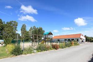a playground in front of a building at Camping Les Vertes Feuilles in Quend