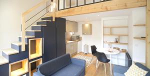 a living room with a blue couch and a table at Appart' Neyret in Lyon