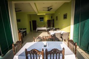 a large dining room with a table and chairs at Sanctuary Tourist Lodge in Bharatpur