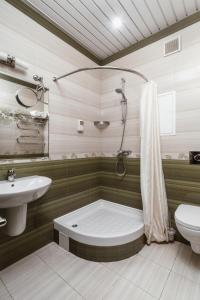 a bathroom with a tub and a toilet and a sink at Hotel Sokol in Moscow
