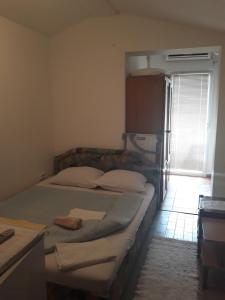 a bedroom with two twin beds and a window at Guest House Olga in Budva