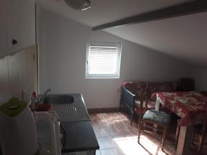 a living room with a couch and a table at Guest House Olga in Budva